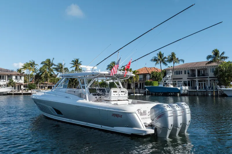 Patti Anne Yacht Photos Pics 2022 Intrepid 409 Valor yacht with triple Mercury engines docked in a scenic waterfront setting.