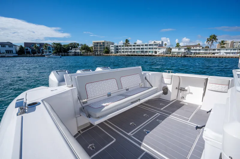 Patti Anne Yacht Photos Pics 2022 Intrepid 409 Valor boat interior with seating, docked by waterfront buildings.