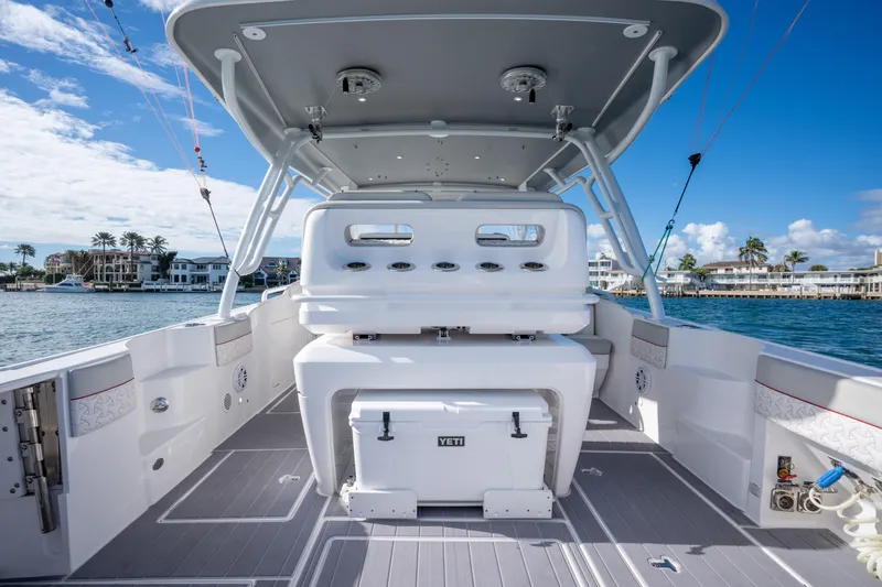 Patti Anne Yacht Photos Pics 2022 Intrepid 409 Valor boat interior with seating and storage, docked by waterfront homes.