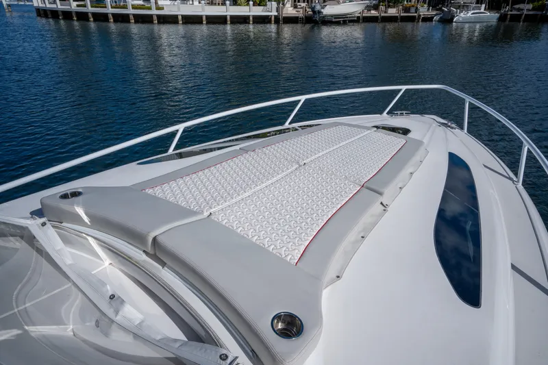 Patti Anne Yacht Photos Pics 2022 Intrepid 409 Valor boat with cushioned deck, docked by the water.