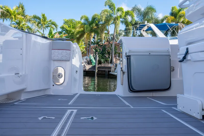 Patti Anne Yacht Photos Pics 2022 Intrepid 409 Valor boat deck with palm trees in background.