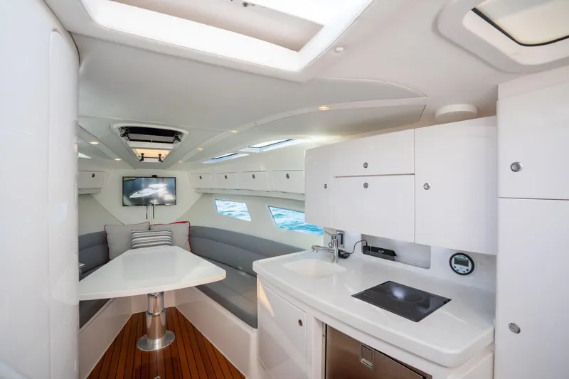 Patti Anne Yacht Photos Pics Luxurious interior of 2022 Intrepid 409 Valor yacht with modern kitchen and seating area.