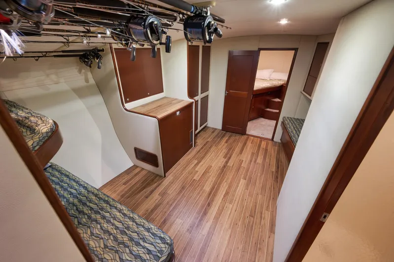 Decoy Yacht Photos Pics Interior of 2002 Paul Mann 60 Custom Carolina yacht with wooden flooring and fishing rods.