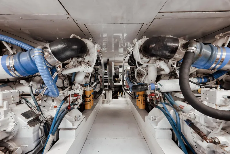 Decoy Yacht Photos Pics Engine room of 2002 Paul Mann 60 Custom Carolina yacht, featuring dual engines and blue hoses.