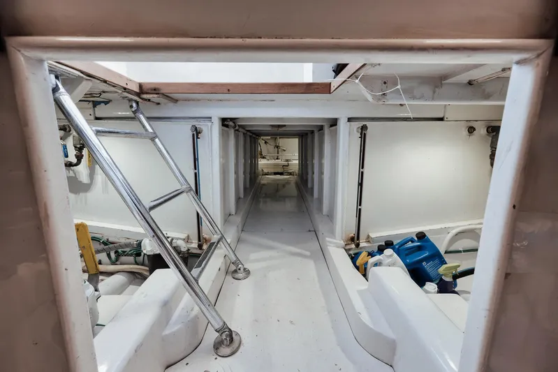 Decoy Yacht Photos Pics Engine room of 2002 Paul Mann 60 Custom Carolina boat, featuring ladder and equipment.