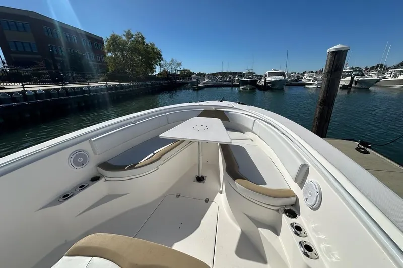 Yacht Photos Pics 2015 Edgewater 320CC boat docked at marina, featuring spacious seating and table.