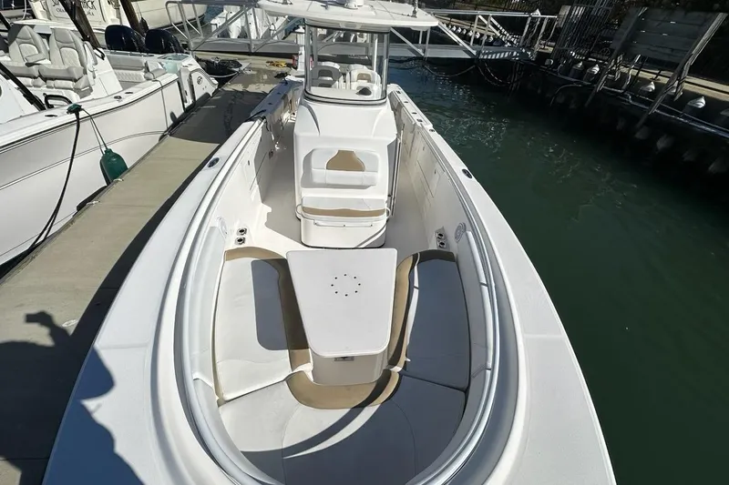  Yacht Photos Pics 2015 Edgewater 320CC boat docked, featuring spacious seating and sleek design.