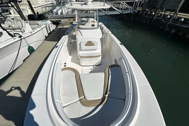  Yacht Photos Pics 2015 Edgewater 320CC boat docked, featuring spacious seating and sleek design.