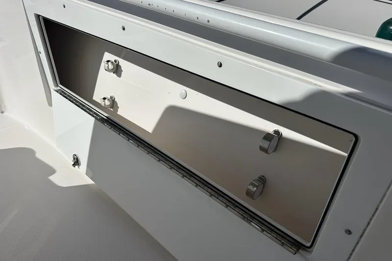  Yacht Photos Pics Storage compartment on a 2015 Edgewater 320CC boat, featuring secure latches.