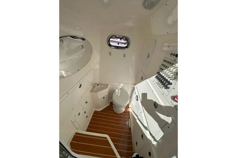  Yacht Photos Pics Interior of 2015 Edgewater 320CC boat featuring a compact bathroom with wooden flooring.