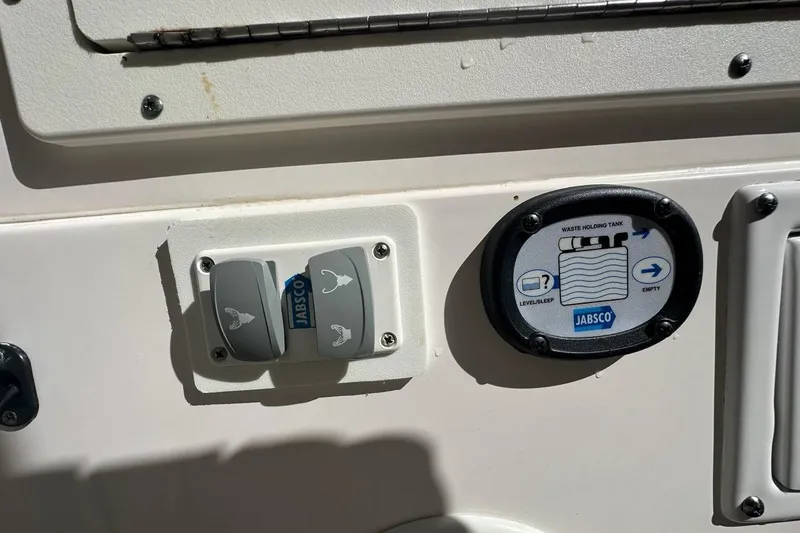  Yacht Photos Pics Control panel on 2015 Edgewater 320CC boat featuring Jabsco waste tank indicators.