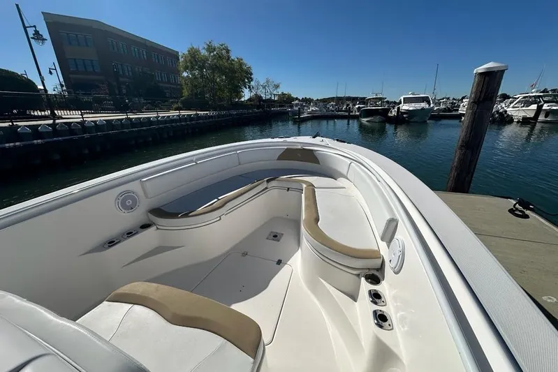  Yacht Photos Pics 2015 Edgewater 320CC boat docked at marina, featuring spacious seating and clear blue sky.