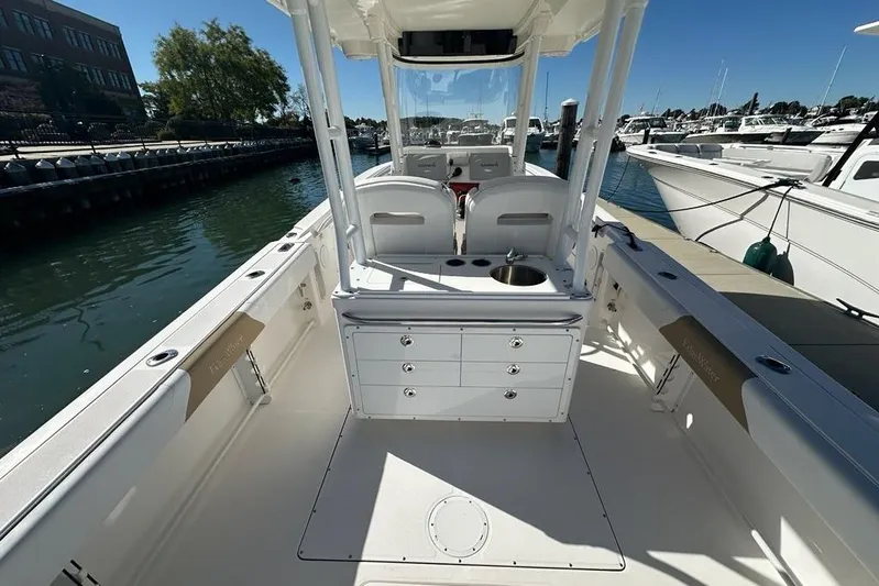  Yacht Photos Pics 2015 Edgewater 320CC boat interior, featuring seating and storage, docked at a marina.