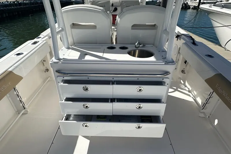 Yacht Photos Pics 2015 Edgewater 320CC boat interior with storage drawers and sink, docked at marina.
