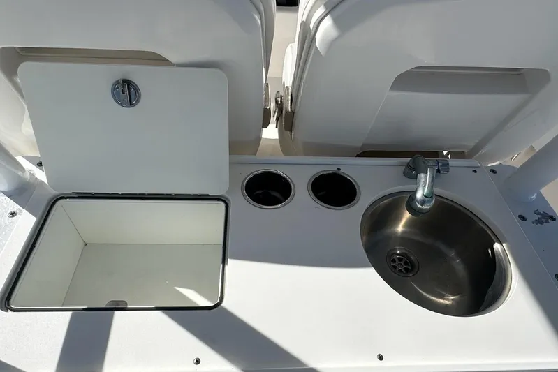  Yacht Photos Pics Edgewater 320CC 2015 boat interior with sink and storage compartment.