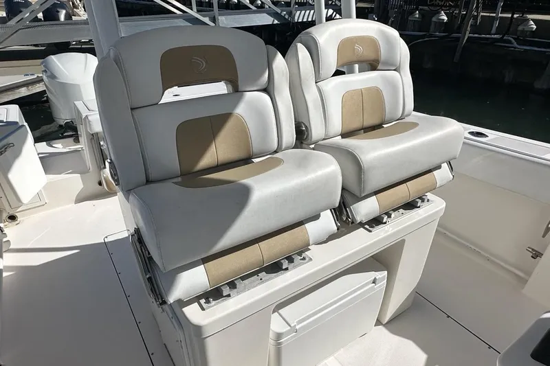  Yacht Photos Pics Luxury seating on 2015 Edgewater 320CC boat, featuring dual cushioned chairs.