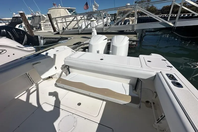  Yacht Photos Pics 2015 Edgewater 320CC boat docked, featuring dual outboard engines and spacious seating area.
