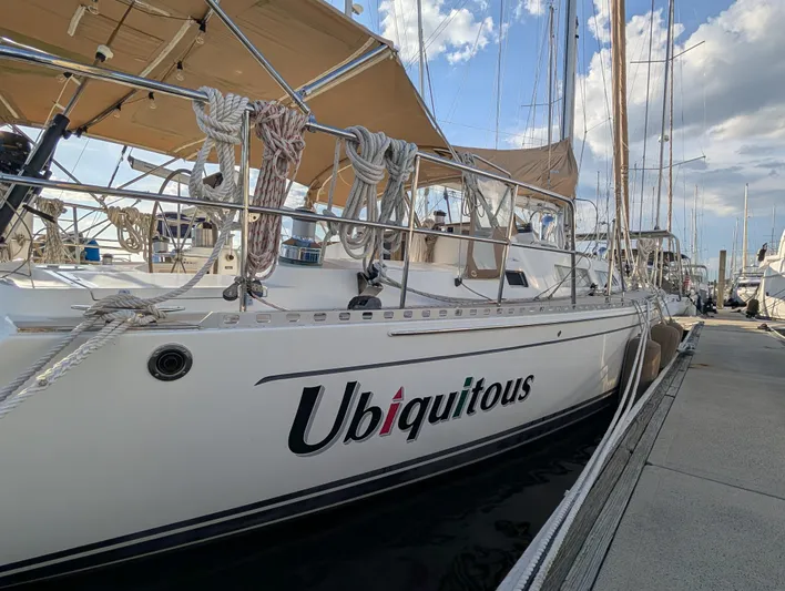 Ubiquitous Yacht Photos Pics Sailboat "Ubiquitous" docked, Outbound 46 model, 2015, with clear skies and marina view.