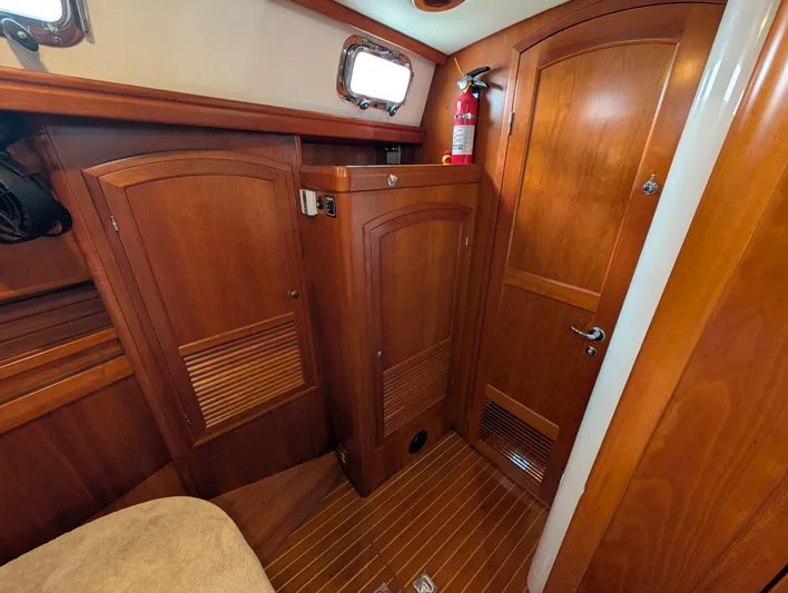 Ubiquitous Yacht Photos Pics Wooden interior of 2015 Outbound 46 yacht cabin with fire extinguisher.