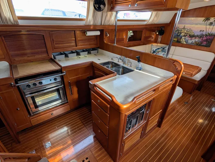 Ubiquitous Yacht Photos Pics Luxurious 2015 Outbound 46 yacht kitchen with wood cabinetry and modern appliances.