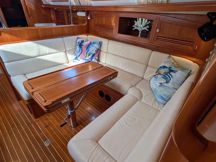 Ubiquitous Yacht Photos Pics Luxurious interior of 2015 Outbound 46 yacht with plush seating and wooden table.