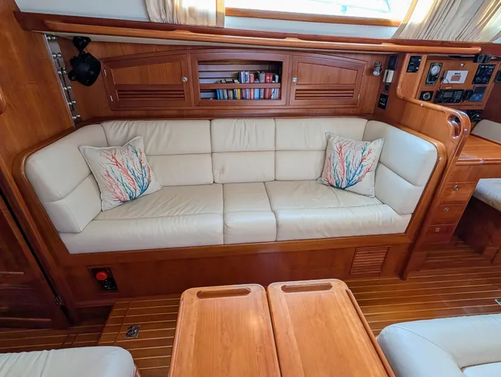 Ubiquitous Yacht Photos Pics Luxurious interior of 2015 Outbound 46 yacht with cream sofa and wooden accents.