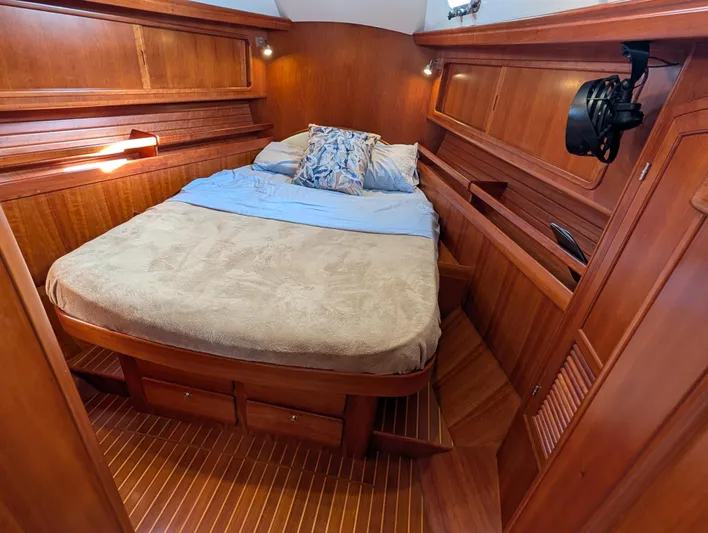 Ubiquitous Yacht Photos Pics Luxurious wooden cabin interior of 2015 Outbound 46 yacht with cozy bed and ambient lighting.