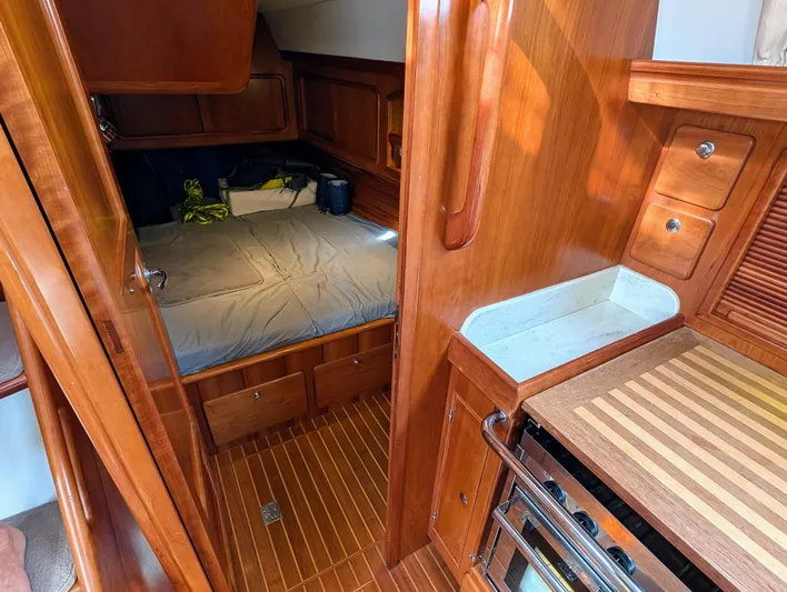 Ubiquitous Yacht Photos Pics Cozy cabin interior of 2015 Outbound 46 yacht with wooden finish and compact bed.