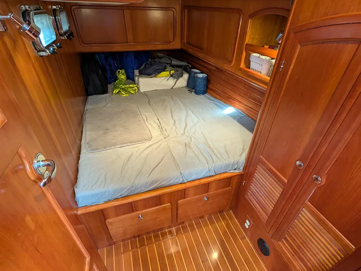 Ubiquitous Yacht Photos Pics Cozy cabin interior of 2015 Outbound 46 yacht with wooden finish and bed.