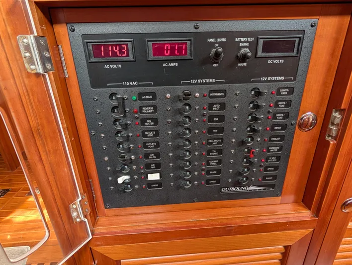 Ubiquitous Yacht Photos Pics Electrical control panel on a 2015 Outbound 46 yacht, featuring AC and DC systems.