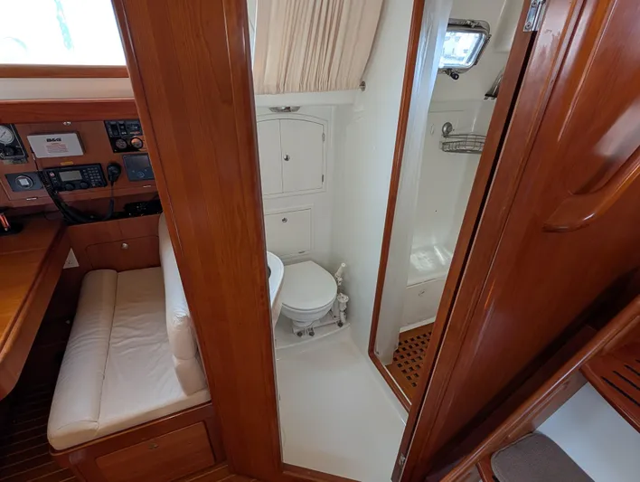 Ubiquitous Yacht Photos Pics Interior of 2015 Outbound 46 yacht showing bathroom and navigation area.
