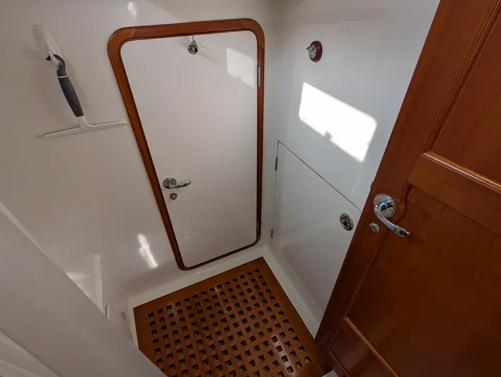 Ubiquitous Yacht Photos Pics Interior of 2015 Outbound 46 yacht, featuring wooden doors and a grid-patterned floor.