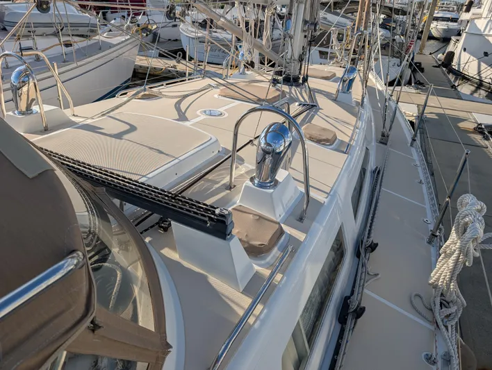 Ubiquitous Yacht Photos Pics Sailboat deck view of 2015 Outbound 46, featuring winches and rigging at marina.