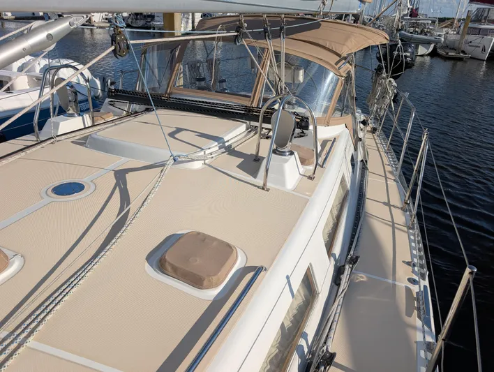 Ubiquitous Yacht Photos Pics 2015 Outbound 46 sailboat deck with beige canopy and rigging, docked at marina.