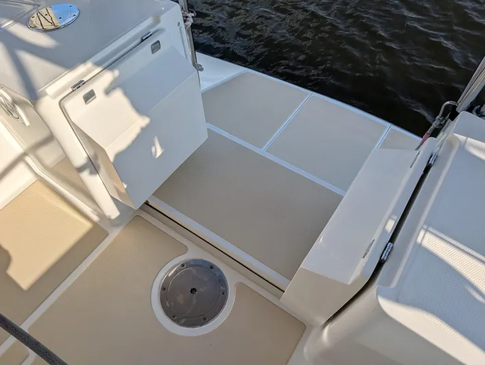Ubiquitous Yacht Photos Pics Deck of 2015 Outbound 46 sailboat with storage compartment and water view.