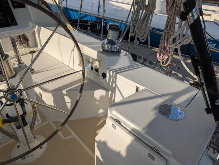 Ubiquitous Yacht Photos Pics Cockpit of 2015 Outbound 46 sailboat with steering wheel and ropes.