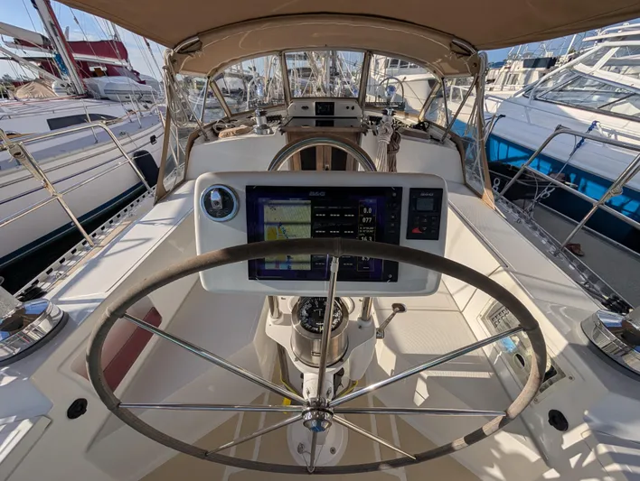 Ubiquitous Yacht Photos Pics Cockpit view of a 2015 Outbound 46 sailboat with navigation equipment.