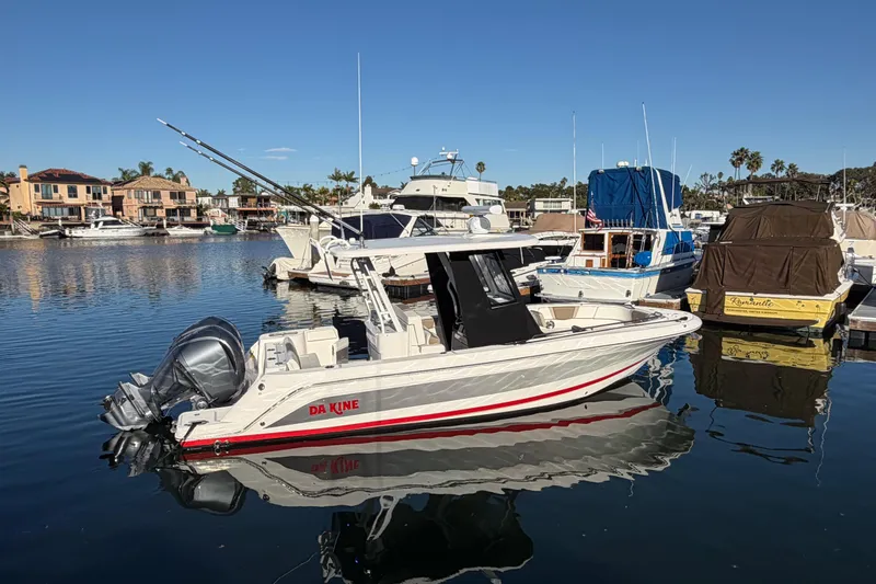Da Kine Yacht Photos Pics 2022 Robalo R272 Center Console boat docked in a marina.