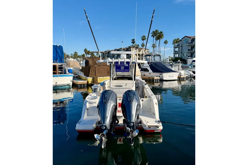 Da Kine Yacht Photos Pics 2022 Robalo R272 Center Console boat docked in a marina with twin engines.