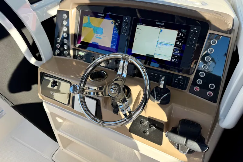 Da Kine Yacht Photos Pics 2022 Robalo R272 Center Console dashboard with dual Simrad displays and chrome steering wheel.