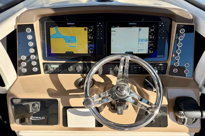 Da Kine Yacht Photos Pics 2022 Robalo R272 Center Console dashboard with dual Simrad displays and chrome steering wheel.