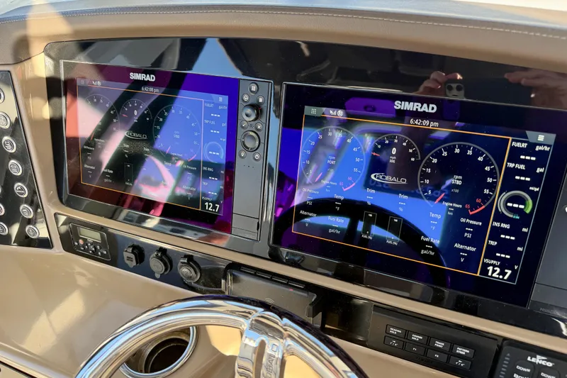 Da Kine Yacht Photos Pics 2022 Robalo R272 Center Console dashboard with dual Simrad displays and steering wheel.
