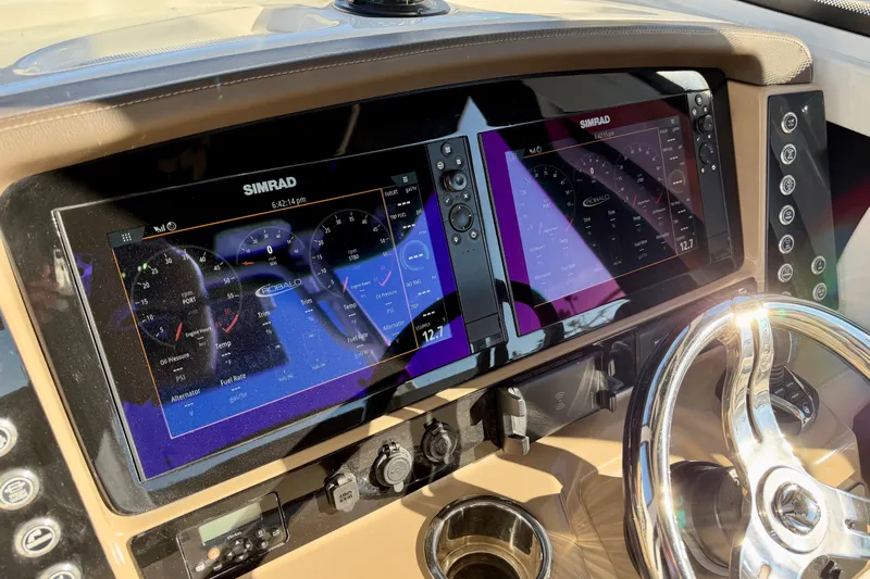 Da Kine Yacht Photos Pics Dashboard of 2022 Robalo R272 Center Console with Simrad displays and steering wheel.