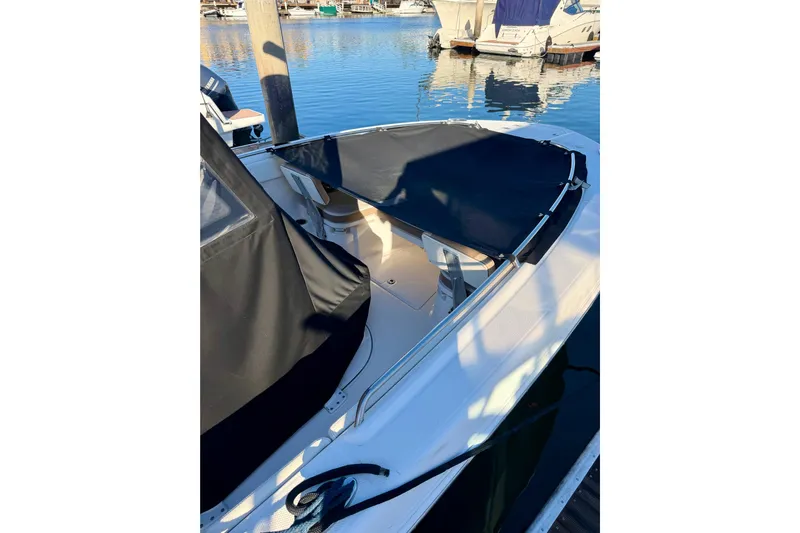 Da Kine Yacht Photos Pics 2022 Robalo R272 Center Console boat with black cover docked at marina.