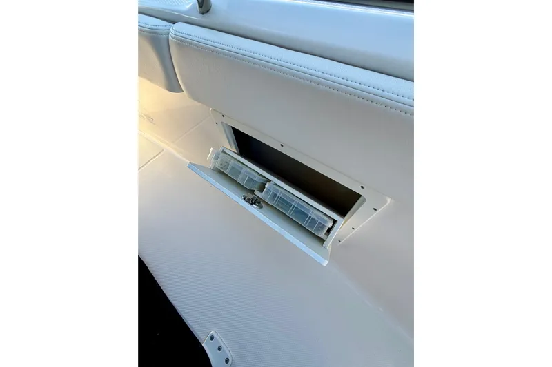 Da Kine Yacht Photos Pics 2022 Robalo R272 Center Console storage compartment with tackle boxes.