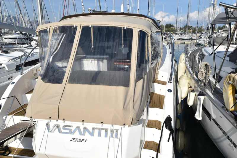 Vasanti Ll Yacht Photos Pics Azimut Atlantis 45 yacht, 2023, docked in a Corfu marina with protective cover.