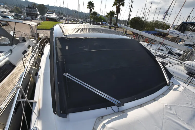 Vasanti Ll Yacht Photos Pics 2023 Azimut Atlantis 45 yacht docked at Greece, Corfu marina, covered windshield, surrounded by boats.