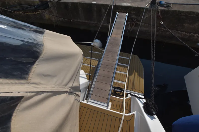 Vasanti Ll Yacht Photos Pics Azimut Atlantis 45 yacht, 2022 model, featuring a sleek gangway and covered deck area.