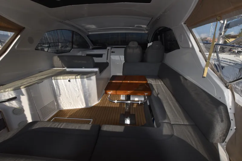 Vasanti Ll Yacht Photos Pics Interior of 2022 Azimut Atlantis 45 yacht with modern seating and wooden table.
