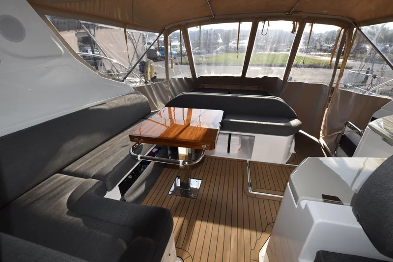 Vasanti Ll Yacht Photos Pics Luxurious interior of 2023 Azimut Atlantis 45 yacht with elegant seating and wooden table.